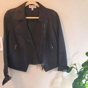 Black leather jacket with silver zipper embellishments.